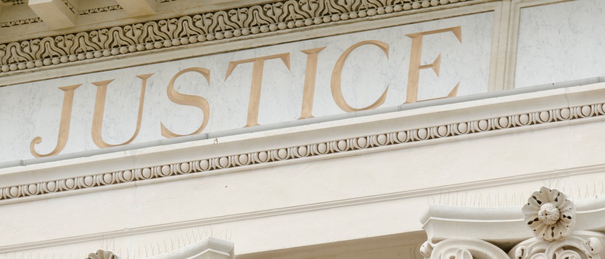 Justice word engraved on the pediment of the courthouse